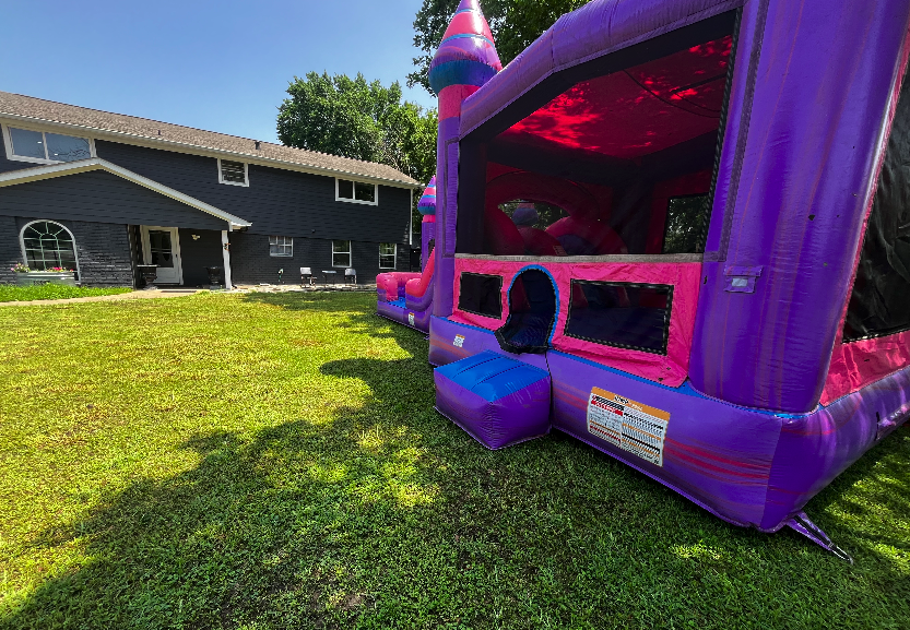 Children enjoying water slide at August birthday party in Sugar Land, combining summer fun and back-to-school excitement