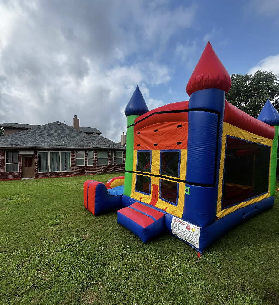 Children playing in a colorful bounce house at a Pearland backyard party